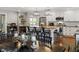 Bright kitchen with island seating, stainless appliances, and hardwood floors adjacent to dining area at 3904 Haverhill Dr, Indianapolis, IN 46240