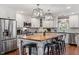 Modern kitchen with white cabinets, butcher block island, stainless steel appliances, and pendant lighting at 3904 Haverhill Dr, Indianapolis, IN 46240
