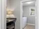 View of a laundry room through an office, with a washer and dryer, plus a window at 3904 Haverhill Dr, Indianapolis, IN 46240