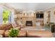 Comfortable living room features a stone fireplace, a large window, and neutral decor at 3904 Haverhill Dr, Indianapolis, IN 46240
