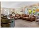 Spacious living room with a large sectional sofa and lots of natural light from the windows at 3904 Haverhill Dr, Indianapolis, IN 46240