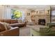 Cozy living room with a stone fireplace, and a sliding door to the outside patio area at 3904 Haverhill Dr, Indianapolis, IN 46240