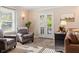 Comfortable sitting area with french doors leading to outdoor patio at 3904 Haverhill Dr, Indianapolis, IN 46240
