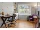 Bright office space with hardwood floors, a built-in bookcase, and a large window at 3904 Haverhill Dr, Indianapolis, IN 46240