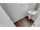 Bathroom featuring hardwood floors, white walls, modern sink and towel rack at 4055 Steelewater Way, Indianapolis, IN 46235