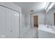 Bathroom featuring a tub and shower, white cabinets, and mosaic tile floor at 4055 Steelewater Way, Indianapolis, IN 46235