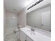 Clean, bright bathroom featuring hexagon tiled floors, large mirror, and shower-tub combo at 4055 Steelewater Way, Indianapolis, IN 46235