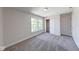 A bright bedroom with neutral paint, plush carpet, and a closet with sliding doors at 4055 Steelewater Way, Indianapolis, IN 46235