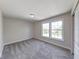 Bright bedroom featuring soft carpet, neutral paint, and natural light streaming through the windows at 4055 Steelewater Way, Indianapolis, IN 46235