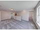 Bonus room featuring gray carpet, natural light, white trim, and neutral walls at 4055 Steelewater Way, Indianapolis, IN 46235