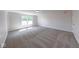 Spacious bonus room featuring gray carpet, natural light, white trim, and neutral walls at 4055 Steelewater Way, Indianapolis, IN 46235