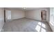 Spacious bonus room featuring gray carpet, natural light, white trim, and neutral walls at 4055 Steelewater Way, Indianapolis, IN 46235