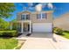Charming two-story home features a covered porch, attached garage and manicured landscaping at 4055 Steelewater Way, Indianapolis, IN 46235