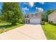 Two-story home with a well-manicured lawn, mature trees, and a two car garage at 4055 Steelewater Way, Indianapolis, IN 46235
