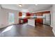 Well-equipped kitchen boasts an island, stainless appliances, and rich wood cabinetry at 4055 Steelewater Way, Indianapolis, IN 46235