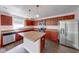 Well-equipped kitchen boasts an island, stainless appliances, and rich wood cabinetry at 4055 Steelewater Way, Indianapolis, IN 46235