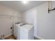 The laundry room features a washer, dryer, and wire shelving unit at 4055 Steelewater Way, Indianapolis, IN 46235