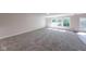 Bright living room with multiple windows and plush gray carpeting and hardwood accent at 4055 Steelewater Way, Indianapolis, IN 46235