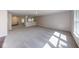 Large living room featuring plush gray carpeting and large windows letting in natural light at 4055 Steelewater Way, Indianapolis, IN 46235