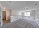 Upstairs loft area featuring fresh carpeting, windows, and updated lighting at 4055 Steelewater Way, Indianapolis, IN 46235