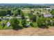 Aerial view of a neighborhood with houses, green trees, and baseball fields in the distance at 410 W Douglas St, Martinsville, IN 46151