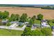 An aerial view shows charming single-story homes, mature trees, and extensive open field views at 410 W Douglas St, Martinsville, IN 46151