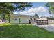 Backyard with a wooden deck and a grassy area, perfect for outdoor activities at 410 W Douglas St, Martinsville, IN 46151