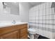 Cozy bathroom featuring wood-look vanity, modern toilet, neutral wall paint, and shower with curtain at 410 W Douglas St, Martinsville, IN 46151