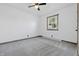 Carpeted bedroom featuring a ceiling fan and natural wood trim around the window and doorway at 410 W Douglas St, Martinsville, IN 46151