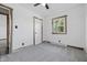 Bright bedroom featuring neutral carpet, a ceiling fan, and a window with natural wood trim at 410 W Douglas St, Martinsville, IN 46151