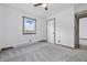 Carpeted bedroom featuring a ceiling fan and natural light from the window at 410 W Douglas St, Martinsville, IN 46151