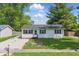 Well-maintained single-story house featuring a charming front yard and a gravel driveway at 410 W Douglas St, Martinsville, IN 46151
