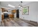 Well-lit kitchen featuring wooden cabinets, modern appliances, gray backsplash, and updated flooring at 410 W Douglas St, Martinsville, IN 46151