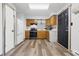 Bright and efficient kitchen with modern appliances, wooden cabinets, stylish backsplash, and vinyl flooring at 410 W Douglas St, Martinsville, IN 46151
