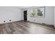 Bright living room features modern flooring, a large window with natural light, and a freshly painted walls at 410 W Douglas St, Martinsville, IN 46151