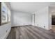 Spacious living room boasts modern flooring, natural light from a window, and neutral-toned walls at 410 W Douglas St, Martinsville, IN 46151