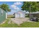 A well-maintained white storage shed in the backyard, providing ample storage space at 410 W Douglas St, Martinsville, IN 46151