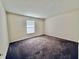 Cozy carpeted bedroom featuring a large window and neutral walls at 413 Woodberry Dr, Danville, IN 46122