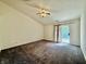Spacious bedroom with plush carpeting, a ceiling fan, and sliding glass doors to the outdoors at 413 Woodberry Dr, Danville, IN 46122