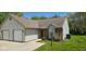Charming home with a brick facade, siding, well-manicured lawn, and attached garage at 413 Woodberry Dr, Danville, IN 46122