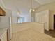 Bright, open kitchen area featuring tiled floors and a seamless transition to the living space at 413 Woodberry Dr, Danville, IN 46122