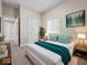 Bright bedroom with a queen bed, nightstands, stylish turquoise accents and a modern design at 429 Colescott St, Shelbyville, IN 46176