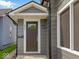 Charming front entrance with a dark-stained front door and modern exterior lighting at 429 Colescott St, Shelbyville, IN 46176