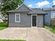 View of the side exterior of the house showing a dark painted door, a window and driveway at 429 Colescott St, Shelbyville, IN 46176