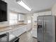 Bright kitchen featuring white cabinets, stainless steel refrigerator, and modern appliances at 429 Colescott St, Shelbyville, IN 46176