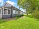 Expansive side yard with lush green grass, beautiful trees, and great curb appeal at 429 Colescott St, Shelbyville, IN 46176
