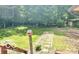 View of the backyard with lawn featuring a birdhouse, trees and shrubbery at 4419 Liberty Loop Rd, Martinsville, IN 46151