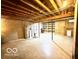 Unfinished basement with exposed wood ceiling, cinder block walls, and ample storage space at 4419 Liberty Loop Rd, Martinsville, IN 46151