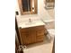 Traditional bathroom with a single sink vanity, wooden cabinets, and a rustic mirror at 4419 Liberty Loop Rd, Martinsville, IN 46151