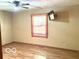 Spacious bedroom with wood floors, a window with blinds, and a mounted TV at 4419 Liberty Loop Rd, Martinsville, IN 46151